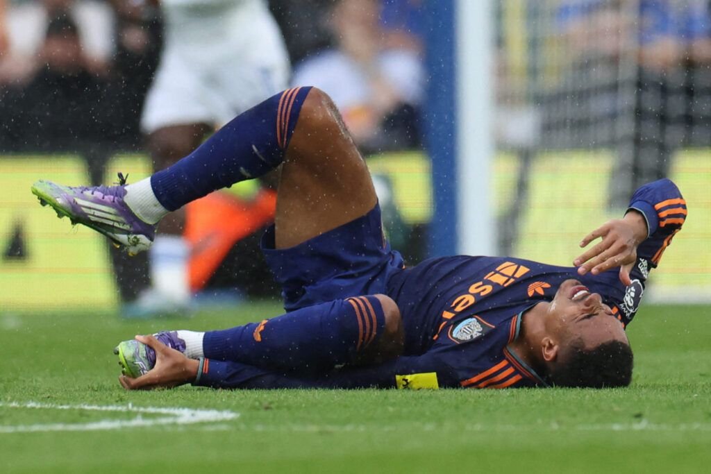 Jacob Ramsey clutches his ankle after injuring it at Elland Road